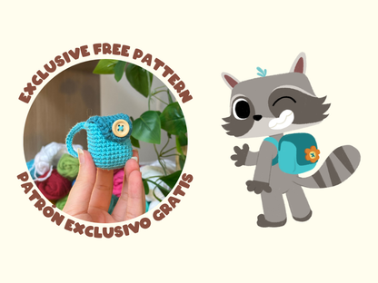 Promotional graphic for an exclusive free crochet pattern, featuring a hand holding a small blue crocheted item with a button, a cartoon raccoon wearing a matching blue backpack, and Spanish text reading 'EXCLUSIVE FREE PATTERN' and 'PATRON EXCLUSIVO GRATIS' on a light cream background.