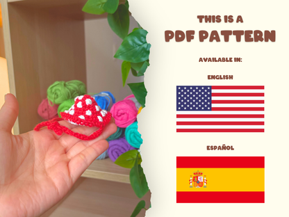 A promotional graphic for a PDF sewing pattern. The left side shows a hand holding a small crocheted red and white hat, with colorful fabric rolls in the background and green leaves hanging down.