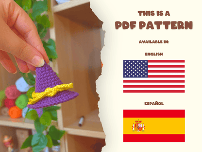 A hand holds a small crocheted purple witch hat with a yellow band on the left, while the right side of the image shows a cream-colored panel with text reading 'THIS IS A PDF PATTERN' and flags for English and Español.