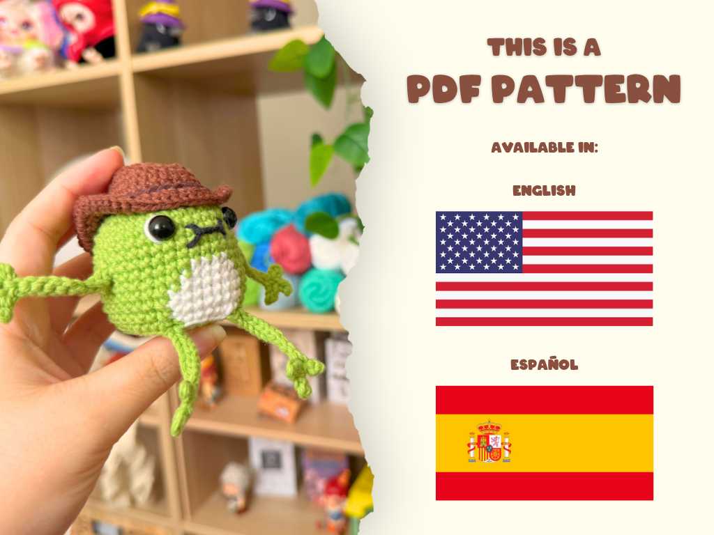 A hand holds a small crocheted frog doll wearing a brown hat and white belly patch in a room with shelves in the background. The right side of the image has a torn-paper style overlay reading 'THIS IS A PDF PATTERN' and showing English and Spanish flags.
