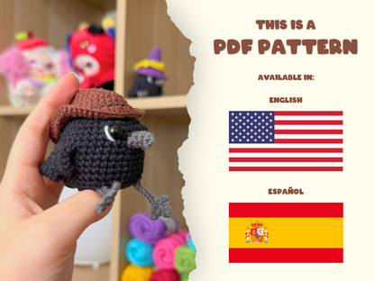 A hand holds a small crocheted bird character wearing a brown hat in the foreground, with a torn-paper style divider on the right showing text that says 'THIS IS A PDF PATTERN' and flags for English and Español.