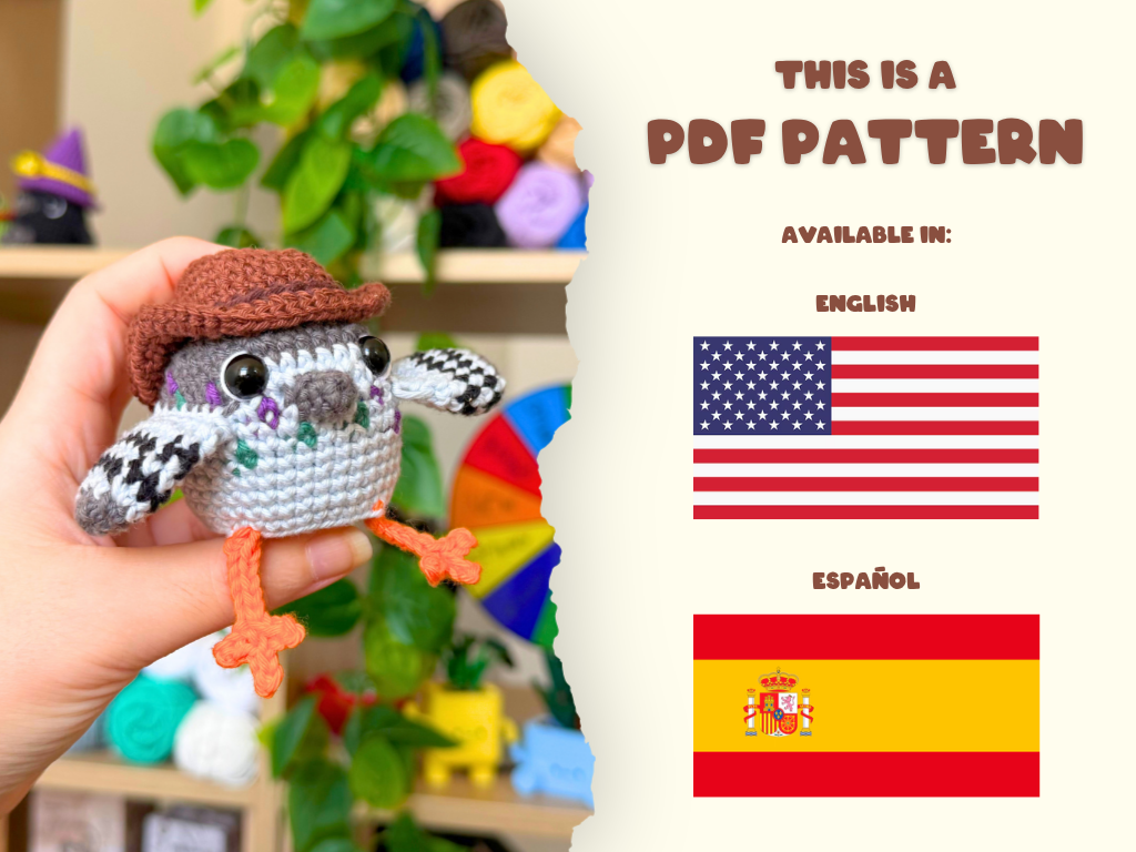 A hand holds a crocheted pigeon toy wearing a brown hat, with a torn-paper style graphic on the right reading 'THIS IS A PDF PATTERN' and showing English and Spanish flags. The background is a softly blurred craft room with colorful yarn balls.