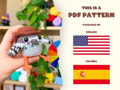 A hand holds a crocheted pigeon toy wearing a brown hat, with a torn-paper style graphic on the right reading 'THIS IS A PDF PATTERN' and showing English and Spanish flags. The background is a softly blurred craft room with colorful yarn balls.