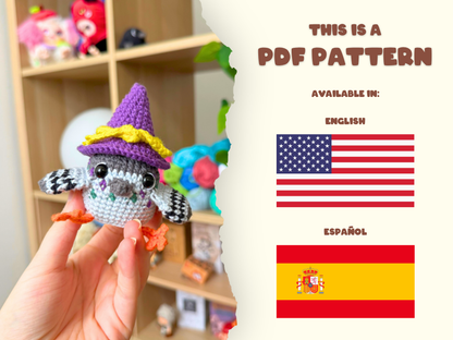 A hand holds a small crocheted pigeon doll wearing a purple witch hat with yellow trim. The left side shows the handmade doll, while the right side has a torn-paper style panel with text reading 'THIS IS A PDF PATTERN' and flags for English and Spanish.
