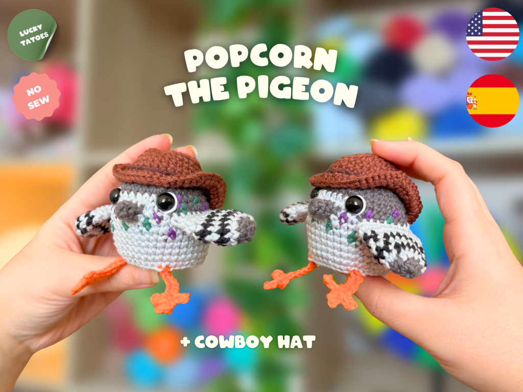 Two handmade crochet pigeon amigurumi dolls wearing brown cowboy hats are held up by two hands against a colorful blurred background. Text overlays read 'POPCORN THE PIGEON', '+ COWBOY HAT', and there are badges including 'LUCKY TATTOOS', 'NO SEW', and flags for USA and Spain.