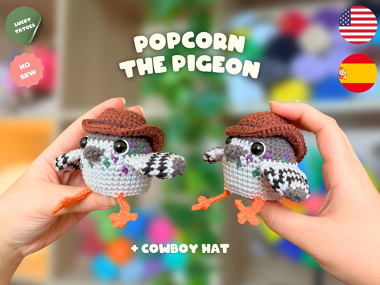 Two handmade crochet pigeon amigurumi dolls wearing brown cowboy hats are held up by two hands against a colorful blurred background. Text overlays read 'POPCORN THE PIGEON', '+ COWBOY HAT', and there are badges including 'LUCKY TATTOOS', 'NO SEW', and flags for USA and Spain.