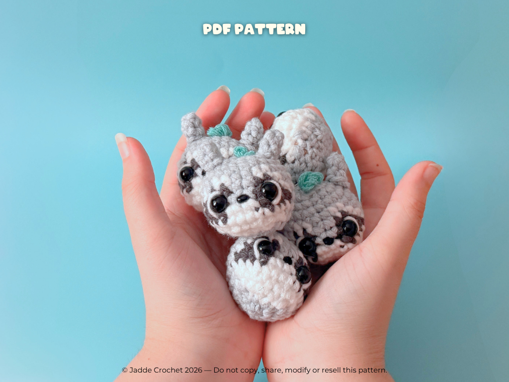 Hand holding two small crochet animals against a light blue background with 'PDF Pattern' text.