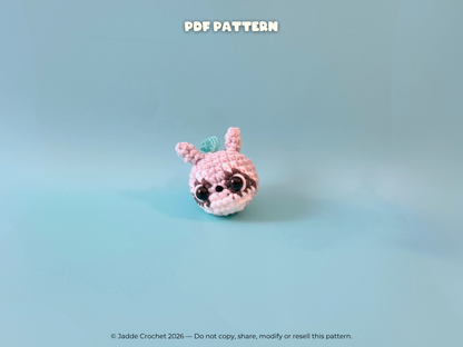 Crocheted raccoon with black eyes on a light blue background, labeled 'PDF Pattern'.